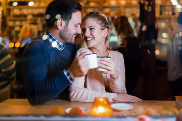 Happy couple drinking at bar and having date