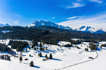 Aerial view, Mittenwald snowy meadow, Alps and Karwendel mountains, Bavaria, Germany