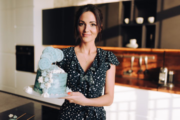 woman posing in loft with cake