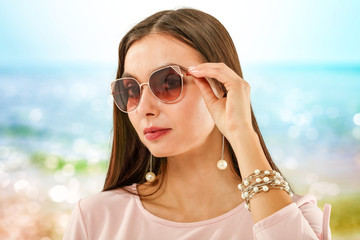 Slim young woman and summer sunglasses 