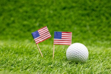 Golf ball with Flag of America on green grass