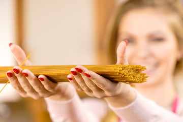 Woman holding long pasta