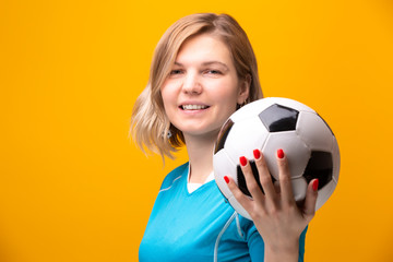 Photo of blonde with soccer ball on yellow background