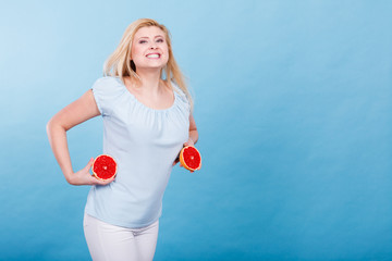 Woman holds grapefruit citrus fruit in hands