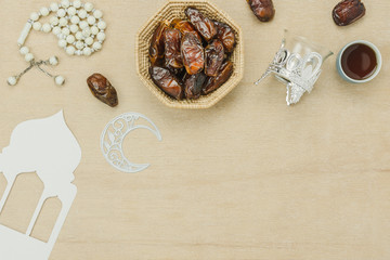 Table top view aerial image of decoration Ramadan Kareem holiday background.Flat lay date with rosary & decor for celebration on modern rustic white wooden at office desk.Copy space creative design.