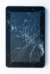 Picture of cracked display on a tablet isolated on white. Tablet with damaged screen
