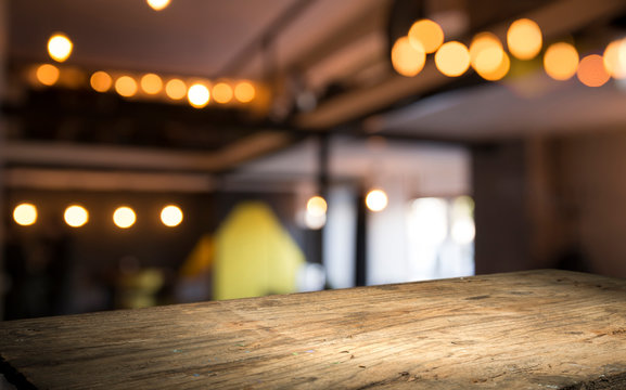 blurred background of bar and dark brown desk space of retro wood