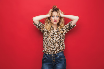 Angry young blonde woman wearing makeup screaming