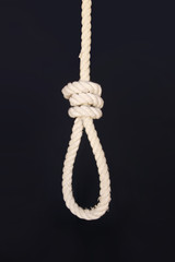 Rope for gallows with hangman noose and hanging knot isolated on a dark background