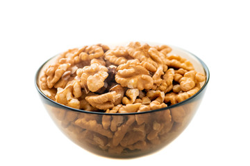 Studio photo of bowl with heap of peeled walnuts isolated on white