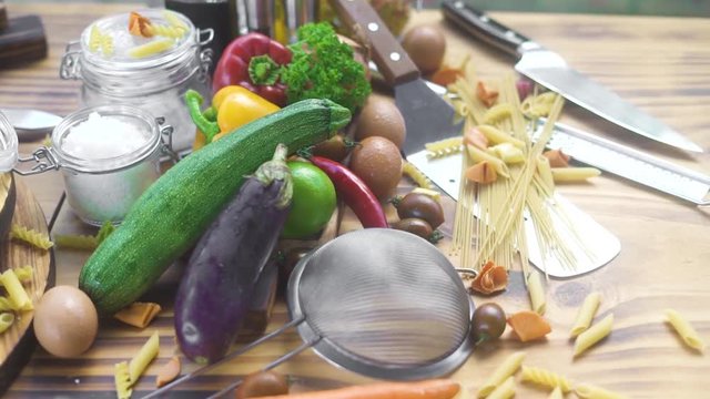 Food composition from fresh vegetable, eggs and macaroni on wooden background. Raw vegetable and ingredient for cooking pizza and pasta. Italian cuisine. Haelthy diet and nutrition.