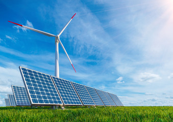 Solar panels and wind turbine on the background of pure blue sky and green grass. Renewable energy Technology saves our planet from pollution and death © Artem Ivanenko