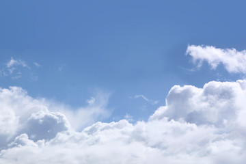 Fototapeta na wymiar Fluffy white clouds on the background of blue sky
