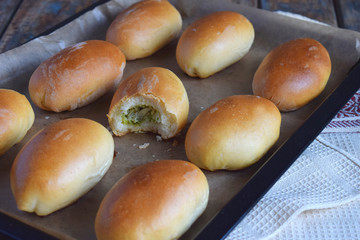 Pies with cabbage and eggs. Baked stuffed patties on metal plate.