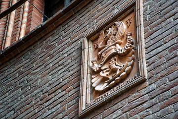 Medieval sculptures on Wall, decorated building with mythical creatures.