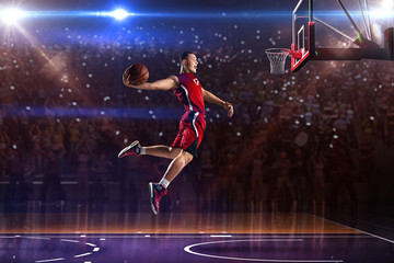 Basketball player in jump. around Arena with blue light spot