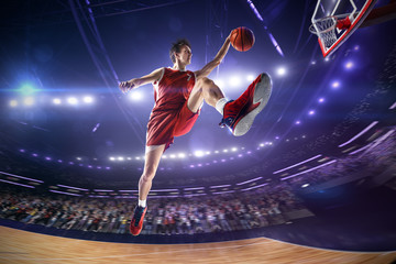 Basketball player in jump. around Arena with blue light spot