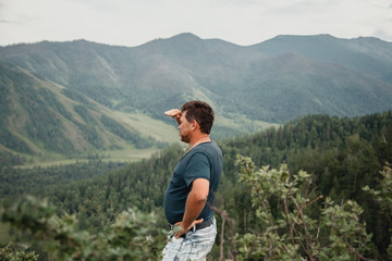 middle-aged man in the highlands looking into the distance