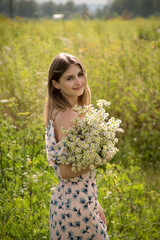 Naklejka na ściany i meble charming girl among the grasses in the summer