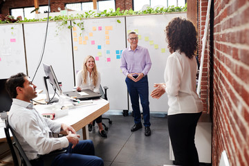 Creative Team Meeting To Discuss Ideas In Modern Office