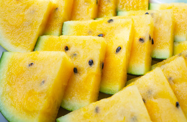 Close up of fresh yellow watermelon triangles. Vegetarian nutrition
