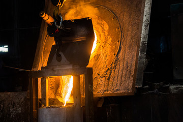 Obraz premium metal casting process with red high temperature fire in metal part factory