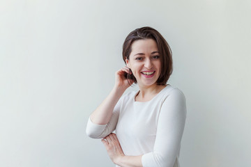 Happy girl smiling. Beauty portrait young happy positive laughing brunette woman on white background isolated. European woman. Positive human emotion facial expression body language