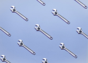 The pattern of adjustable wrenches on a blue background.