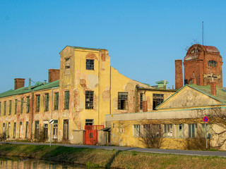 Abandoned factory next to a canal in evening light