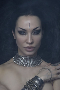Beautiful Woman Bellydancer with Eastern Makeup and Oriental Jewelry (Indian, Arab, African, Egyptian). Tribal Fusion Sexy Girl. Female face, Mystic smoke. Indian Silver accessory