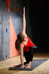Young Active Woman Practising Yoga in Climbing Gym. Healthy and Active Lifestyle.