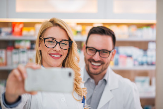 Male and female pharmacist taking a selfie.