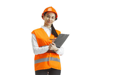 Destroying gender stereotypes. Female builder in orange helmet standing on white studio background. Safety specialist, engineer, occupation, businesswoman, job concept. Woman in the male profession