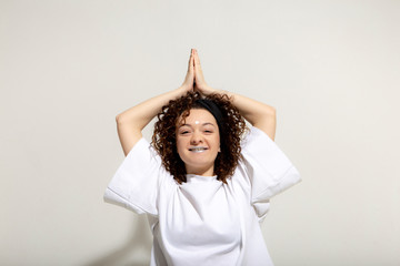 People, youth, leisure and lifestyle concept. Fashionable Caucasian young female student wearing stylish white shirt clothing laughing happily, having fun in photo studio. Copy Space