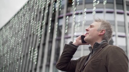 Business man using a phone in a city with matrix numbers.  Man holding a phone with a city office block in the background and an overlay of electronic numbers. - Powered by Adobe