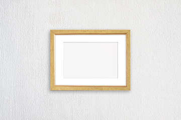Photo frame isolated on white plastered wall, realistic golden framework mock up