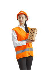 Destroying gender stereotypes. Female builder in orange helmet standing with brick on white studio...