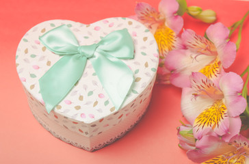  gift box with alstroemeria flowers on pastel  background. Spring composition. Springtime. Mother`s day card