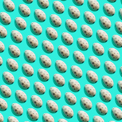 Pattern of Easter eggs with memphis style print on turquoise bright background.  Happy spring holidays concept.