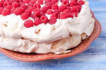 pavlova cake with raspberries and whipped cream
