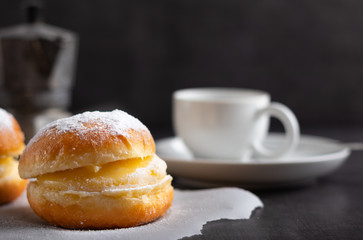 berlin donut with a cup of coffee in the background