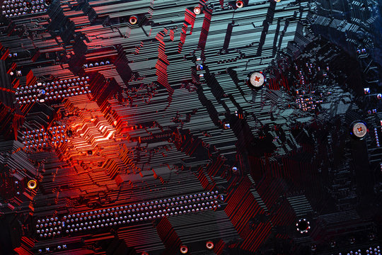 Close up macro of electronic chip in red and black colors. Background texture with copy space. Computer elements, abstract motherboard. Connection, technology and internet concept