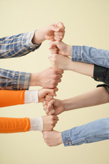 Group of people holding hands together on light background. Concept of unity