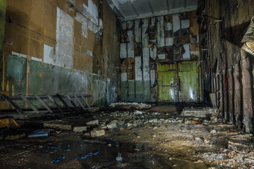 Fototapeta na wymiar Inside abandoned machine hangar or warehouse waiting for demolition