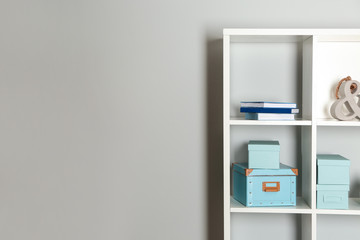 Modern shelf unit near white wall