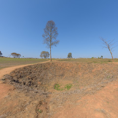 Fototapeta na wymiar A large bomb crater at the Plain of Jars, Thong Hai Hin Site 1, at Thomghaihin near the town of Phonsavan in the province Xieng Khuang in Laos in Southeastasia.