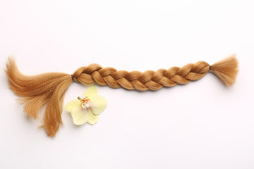 Braided strand on white background. Concept of hair donation