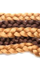 Braided strands on white background. Concept of hair donation
