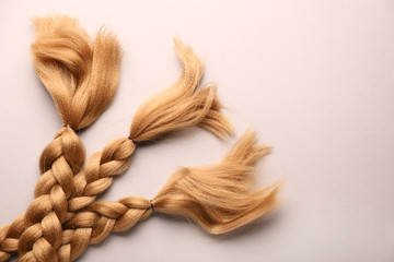Braided strands on light background. Concept of hair donation