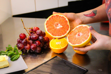 The chef is cooking a New York cheesecake. Cuisine. Fruits. Decorating the dishes. Oranges, grapefruits. Burning Sugar. Filling Sugar Powder